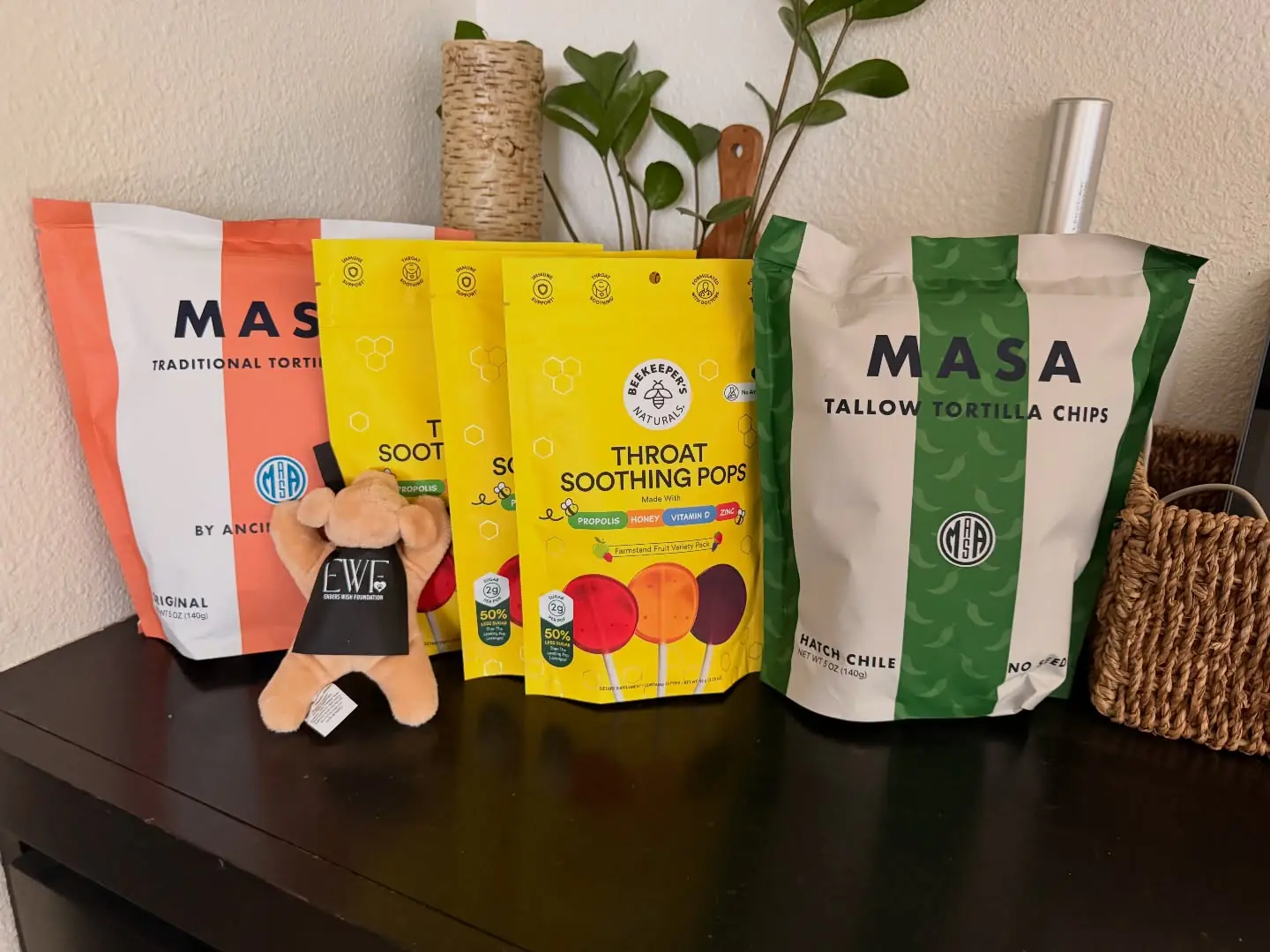 Donated raffle items received by Ender's Wish Foundation, including tortilla chips and wellness pops, alongside a branded plush toy